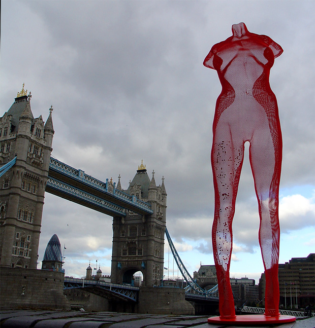 red semi-transparent sculpture of a girl in front of Tower Bridge London